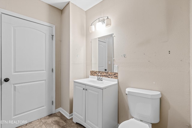 bathroom featuring toilet and vanity