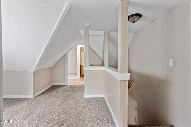 bonus room with baseboards, carpet flooring, and vaulted ceiling
