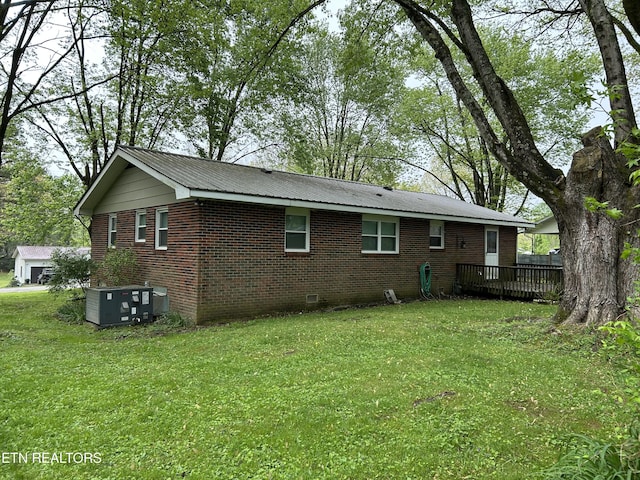 131 Oak Hill Dr, Jamestown, TN 38556 - back of property featuring a lawn, brick siding, a wooden deck, and crawl space