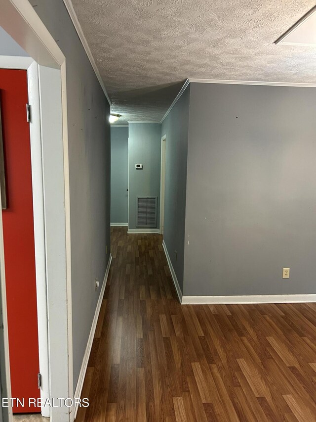 131 Oak Hill Dr, Jamestown, TN 38556 - corridor featuring a textured ceiling, visible vents, wood finished floors, and baseboards