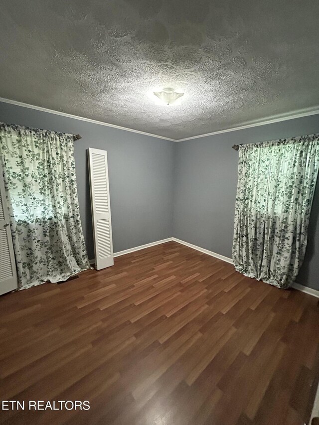 131 Oak Hill Dr, Jamestown, TN 38556 - unfurnished room featuring a textured ceiling, wood finished floors, crown molding, and baseboards
