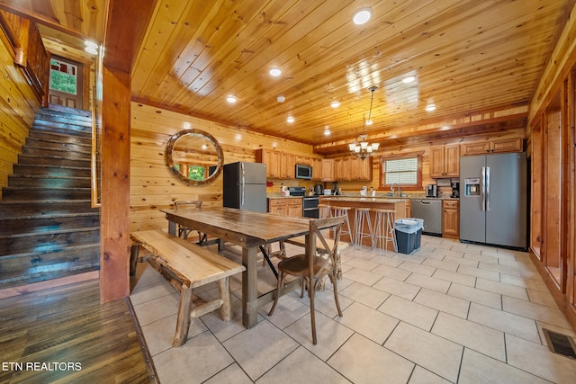 3238 Smoky Ridge Way, Sevierville, TN 37862 - dining space with wooden walls, a chandelier, recessed lighting, wooden ceiling, and light tile patterned floors