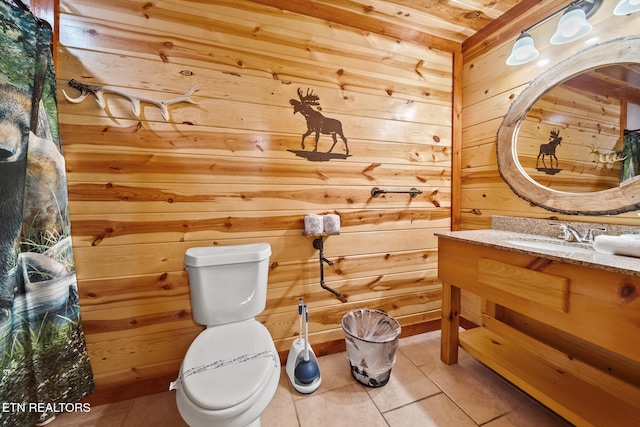 3238 Smoky Ridge Way, Sevierville, TN 37862 - bathroom with wooden walls, vanity, tile patterned flooring, and toilet