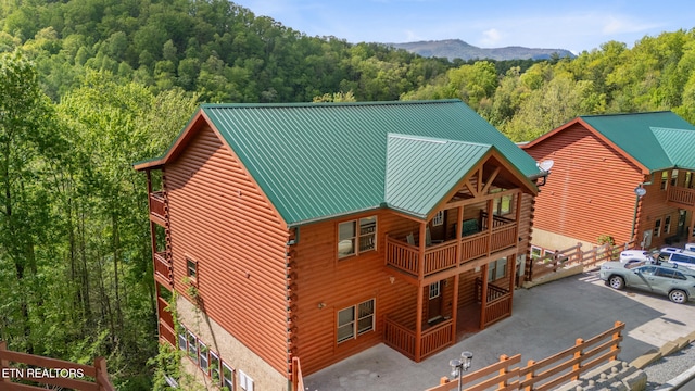 3238 Smoky Ridge Way, Sevierville, TN 37862 - exterior space with a forest view, log siding, metal roof, and a balcony