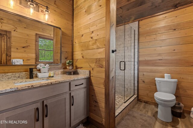 bathroom featuring a shower stall, wood walls, and toilet