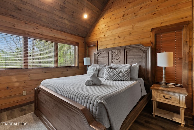bedroom with vaulted ceiling, wood walls, dark wood-style floors, and wooden ceiling