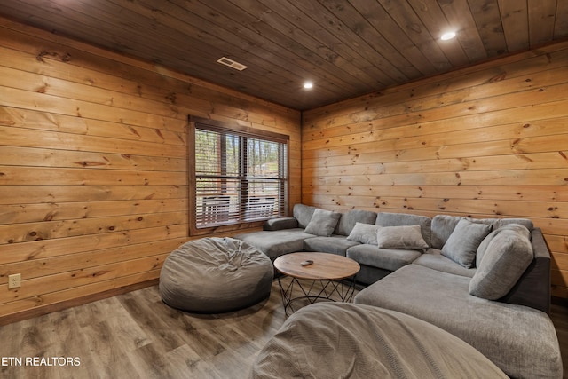 living room featuring wood finished floors, wooden ceiling, wood walls, and recessed lighting