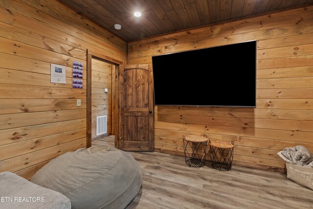 interior space with wood finished floors, wooden walls, wooden ceiling, visible vents, and recessed lighting