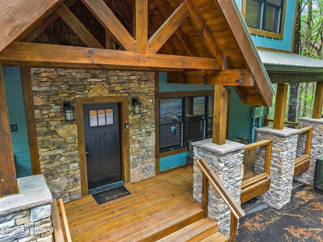 entrance to property with stone siding and metal roof