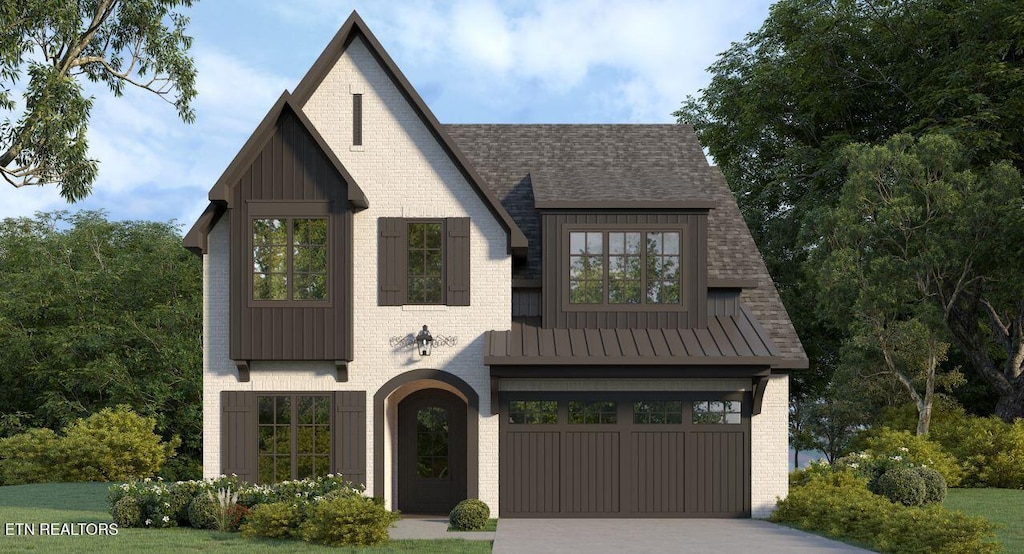 modern farmhouse style home featuring driveway, board and batten siding, a standing seam roof, metal roof, and a garage