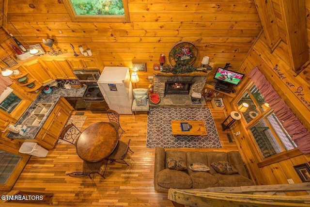 1823 Laurel Valley Way, Sevierville, TN 37862 - living room with hardwood / wood-style flooring, wood walls, and a stone fireplace