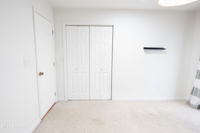 unfurnished bedroom with a closet and baseboards