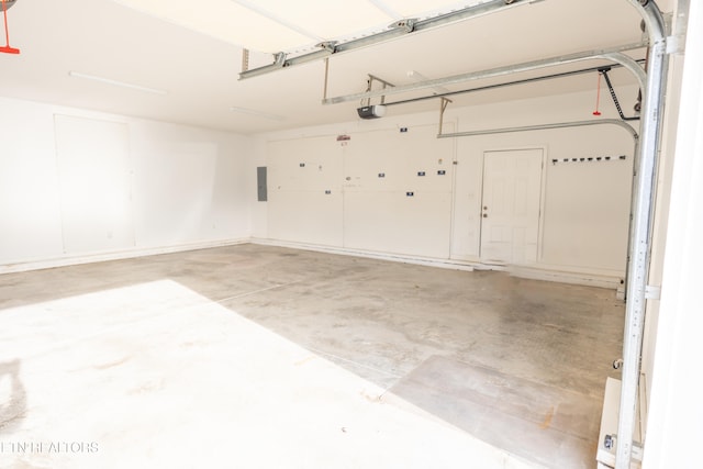 garage with electric panel and a garage door opener