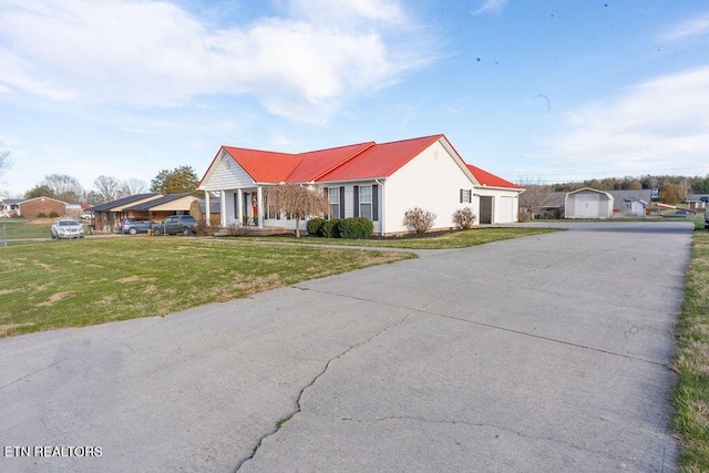 view of front of house with a front lawn and metal roof