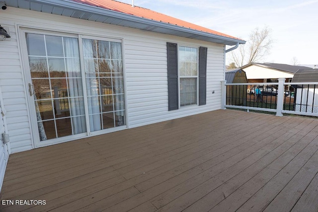 wooden deck featuring a shed
