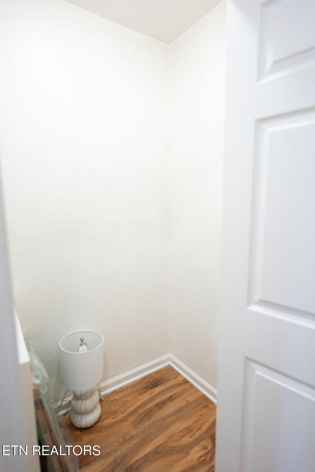 interior space with wood finished floors and baseboards