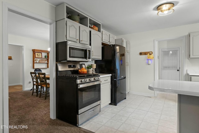 kitchen featuring appliances with stainless steel finishes, gray cabinetry, light countertops, and baseboards