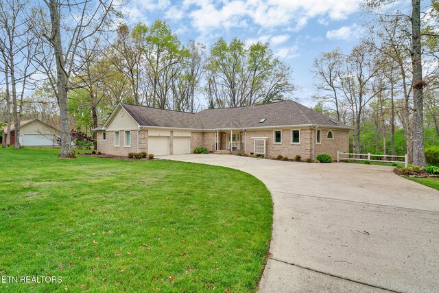 662 Laurel Cir, Crossville, TN 38555 - ranch-style home featuring a front lawn, driveway, brick siding, and a garage