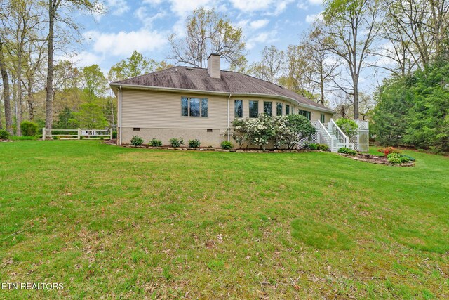 662 Laurel Cir, Crossville, TN 38555 - rear view of property with a lawn, crawl space, and a chimney