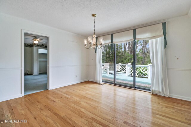 662 Laurel Cir, Crossville, TN 38555 - empty room with ornamental molding, a notable chandelier, a textured ceiling, and light wood finished floors