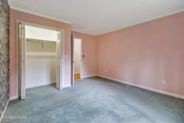 662 Laurel Cir, Crossville, TN 38555 - unfurnished bedroom featuring a closet, carpet floors, crown molding, and baseboards