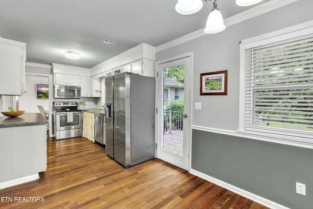 kitchen with baseboards, dark wood-style floors, ornamental molding, stainless steel appliances, and white cabinetry