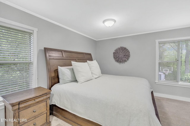 bedroom featuring crown molding, baseboards, multiple windows, and light carpet