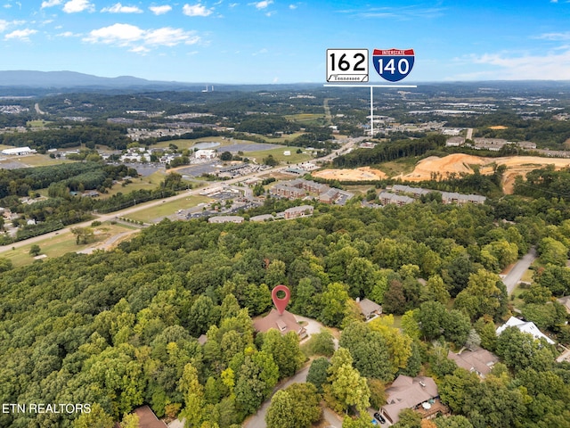 drone / aerial view with a wooded view