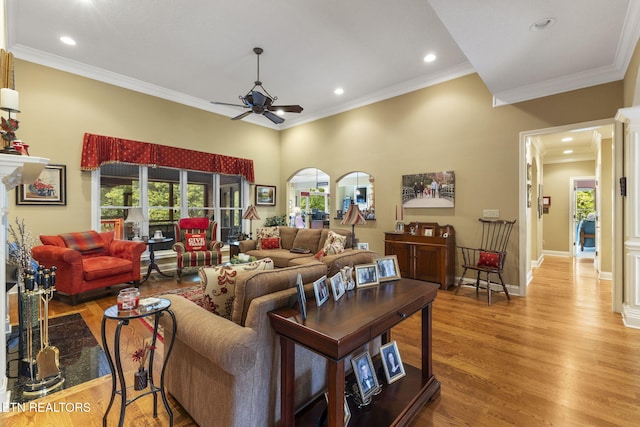 living area with crown molding, a ceiling fan, recessed lighting, and light wood-style flooring