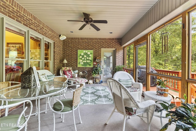 sunroom / solarium with plenty of natural light and a ceiling fan
