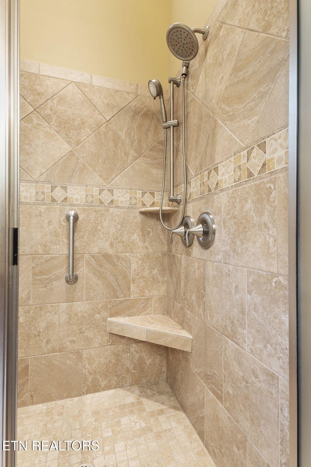 full bathroom with tiled shower