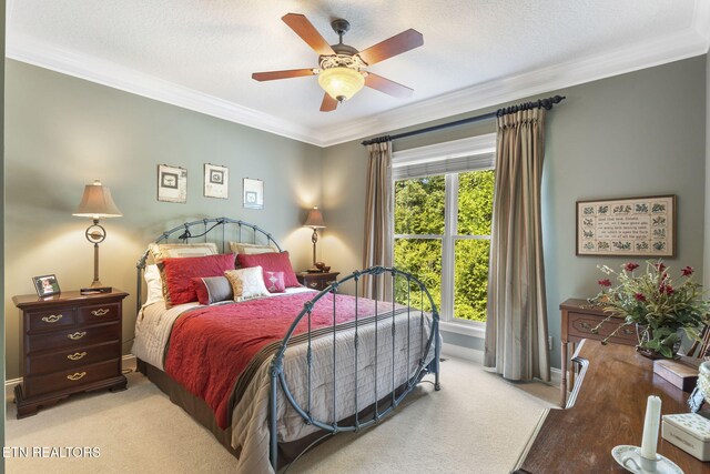 bedroom with baseboards, ornamental molding, and a ceiling fan
