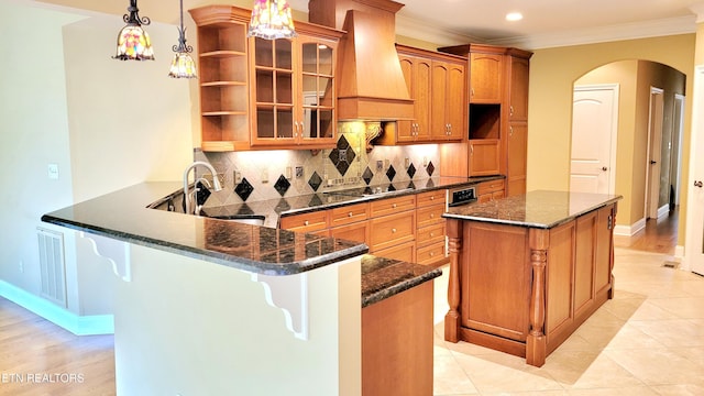 kitchen featuring custom range hood, arched walkways, open shelves, and crown molding