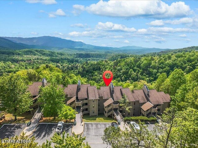 drone / aerial view with a mountain view and a forest view