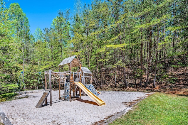 view of play area featuring a forest view