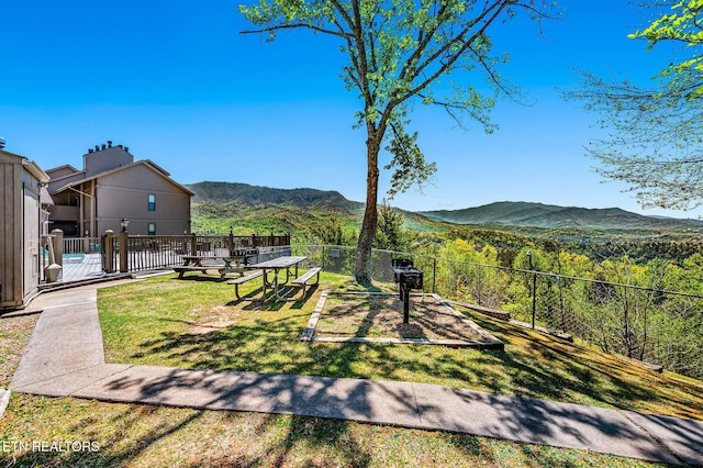 view of yard featuring fence and a mountain view