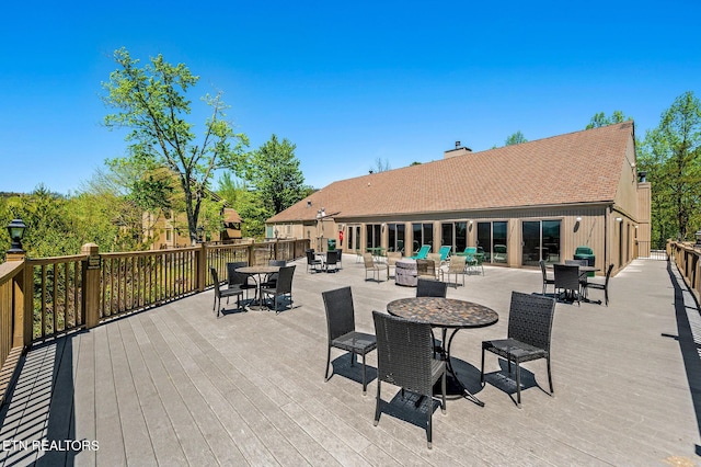 view of patio / terrace featuring outdoor dining space and a deck