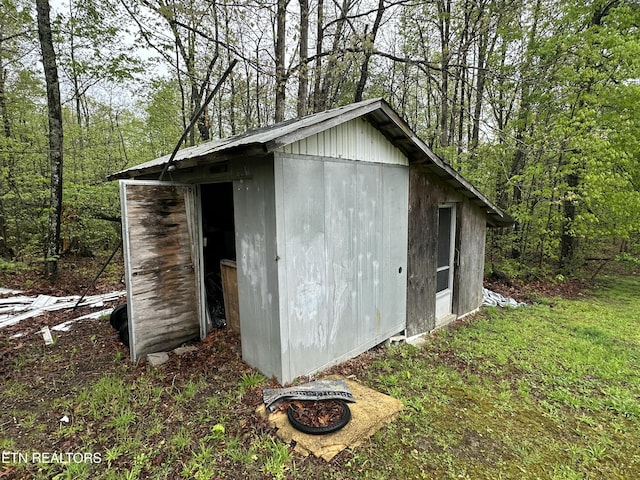 view of shed with a view of trees