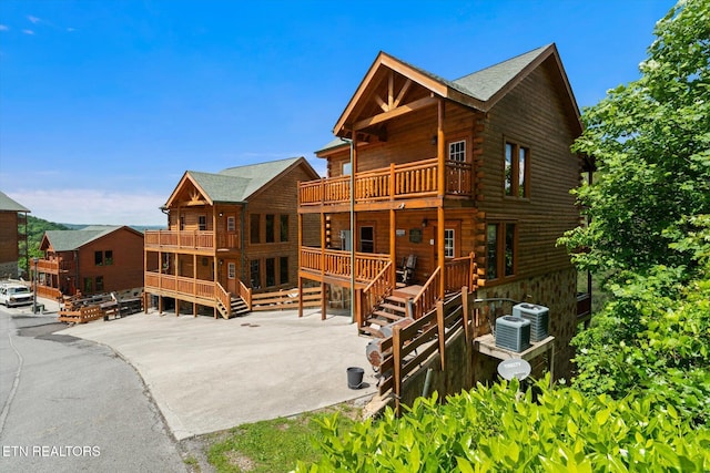 1230 Bird Nest Way, Sevierville, TN 37862 - rear view of house featuring a balcony, stairway, central AC, and log exterior
