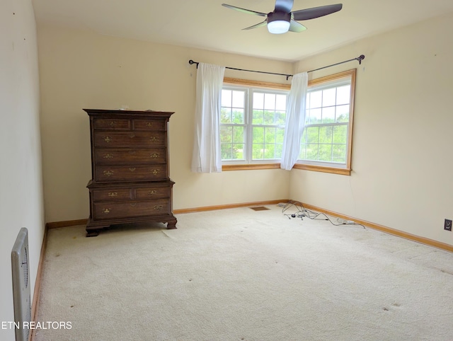 unfurnished bedroom with baseboards, visible vents, ceiling fan, and carpet floors
