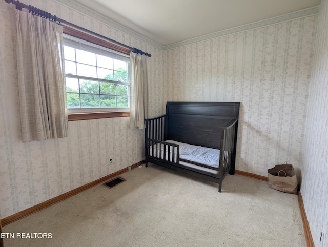 carpeted bedroom featuring baseboards and visible vents