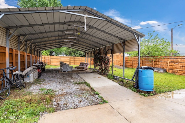 view of parking / parking lot featuring a fenced backyard and a carport