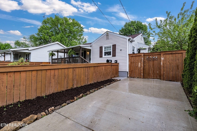 rear view of house featuring fence private yard