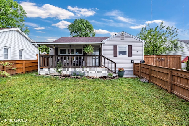 back of property featuring a fenced backyard, roof with shingles, and a yard