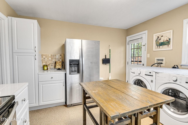 clothes washing area featuring light floors and separate washer and dryer