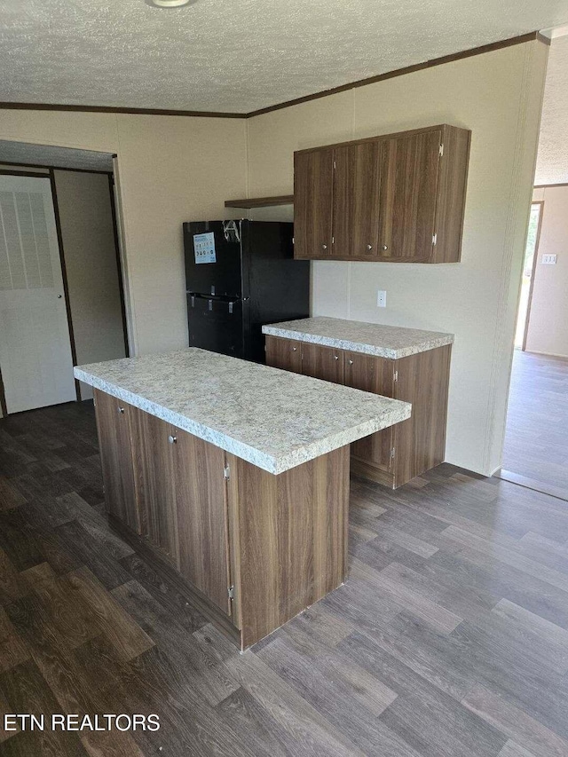 431 Mccroskey St, Englewood, TN 37329 - kitchen with freestanding refrigerator, dark wood-style flooring, ornamental molding, and light countertops