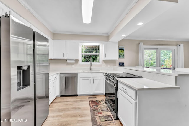 kitchen with crown molding, recessed lighting, a sink, and appliances with stainless steel finishes
