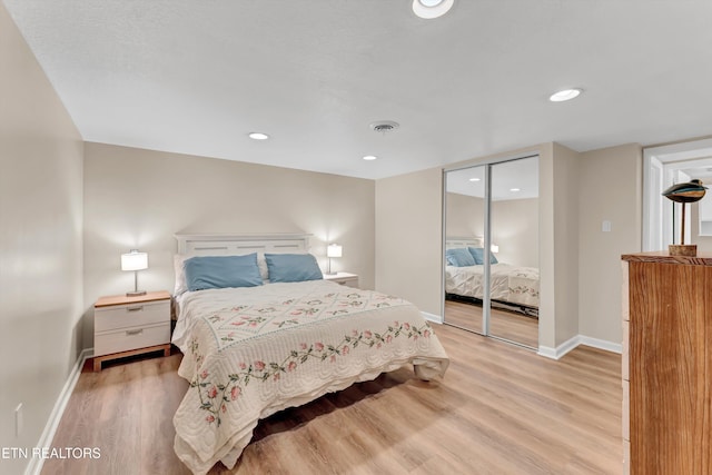 bedroom featuring recessed lighting, a closet, light wood-type flooring, visible vents, and baseboards