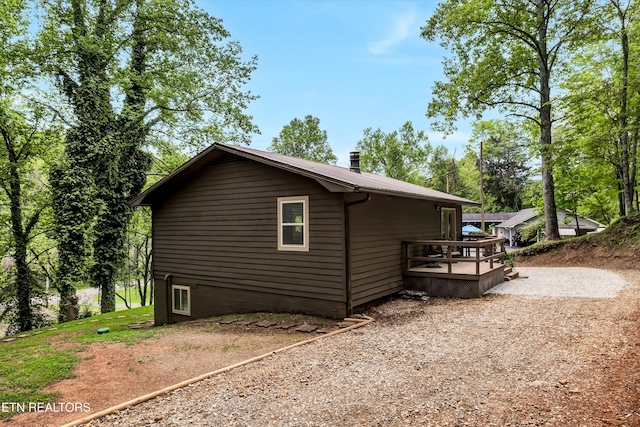 view of side of home with a wooden deck