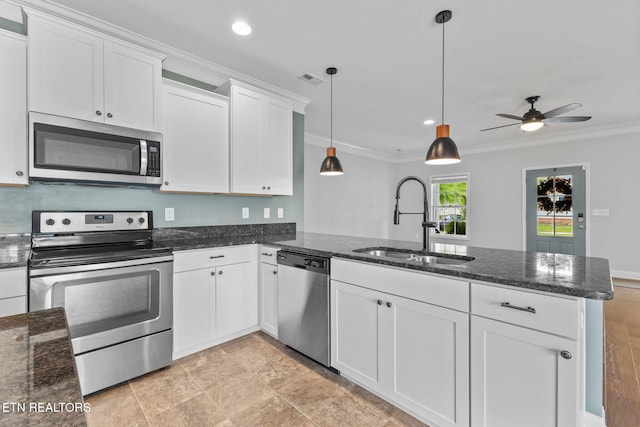 101 Fortenberry St, Oak Ridge, TN 37830 - kitchen featuring crown molding, white cabinets, a sink, stainless steel appliances, and a peninsula